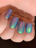 Iridescent blue multichrome manicure on short nails with rainbow aurora finish