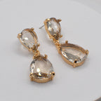 Teardrop dangle earrings with clear faceted stones and gold-tone chain drops