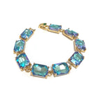Gold-tone linked bracelet with emerald-cut aqua and teal crystal stones