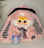 Pink plush bunny with striped sleeves, black bow tie collar and heart-shaped nose