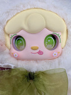 Close-up bunny plush head with pastel face and green bow