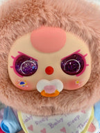 Close-up plush baby doll face with glittery purple eyes, rosy cheeks, pacifier