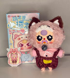 Plush baby kitten with pink fur, brown plaid overalls, and round pendant badge on chest