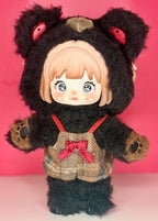 Black plush articulated bear doll with red eye accents, blond hair, red bow accessory