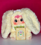 Cream plush bunny pendant with green check outfit and hanging illustrated accessory card