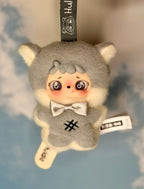 Gray popsicle plush doll with teddy ears, white bow, and small hang tag