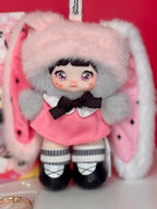 Pink bunny-hood plush figure doll with black bow, pink dress, and striped stockings