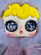 Plush mouse face with yellow hair, blue glitter eyes, and small pink mouth