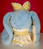 Blue bunny plush back view with yellow check bow and white skirt