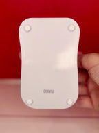 White wooden phone stand back with corner mounting holes and small code stamp