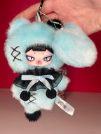 Light blue plush character pendant keychain with chain, black outfit and white emblem