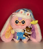 Pink and white plush bunny hood with character face, blue outfit, and bear accessory