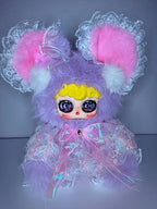 Lavender plush mouse with pink ear cuffs, pastel dress, and big glitter eyes