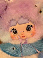 Close-up plush designer doll with glitter stars, big eyes, and blue dress