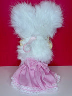 Pale blue plush character with heart details, yellow muzzle, and pink bow dress
