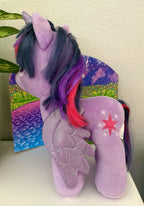 Purple plush pony standing with dark-blue wings and star on side