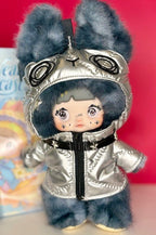 Gray plush hooded doll in silver metallic jacket with cute face, front view.