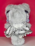 Gray plush articulated doll back view with bear-ear hood and ruffled white dress detail
