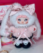 White bunny-hood plush figure doll with pink bow, pearl collar, and dark skirt
