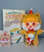 Yellow plush cat pendant with orange face, red cone hat, and blue hanging strap