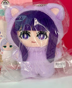 Lavender cat plush pendant with cartoon face, purple eyes, and pink inner ears in wrapper.