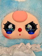 Close-up plush bunny face with oversized glittery eyes, red nose, and blue fur