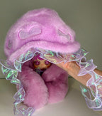 Lilac jellyfish-hat plush with holographic tentacle ribbons held in hand