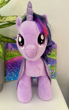 Purple plush pony with black mane, pink tail and star-pattern flank, big eyes