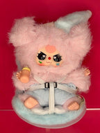 Light pink plush animal in baby carseat cradle, front view with chest harness strap
