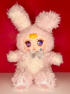 Pink curly plush bunny doll with glitter eyes, yellow nose, and satin bow