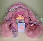 Lilac plush doll with jellyfish hood and holographic ribbons, with product hang tag