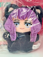 Purple cat plush pendant with cartoon face, big eyes, and pink inner ears in wrapper.