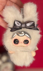 White plush keychain with silver bow, rabbit charm necklace, and round eyes