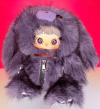 Purple-gray fuzzy plush backpack with hood, zipper, and wide-eyed doll face