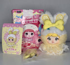 Plush bunny charm doll with yellow bow ears and lace cream dress, in gift box