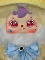 Close-up plush fairy doll face with purple hair, glossy pink eyes, blue bow dress