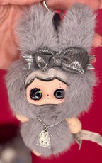 Gray plush keychain with big silver bow, rabbit charm necklace, and cute face