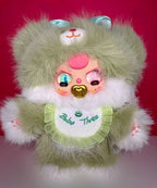 Light green plush bunny with pink face, ruffled bib, and 'Baby Three' shirt