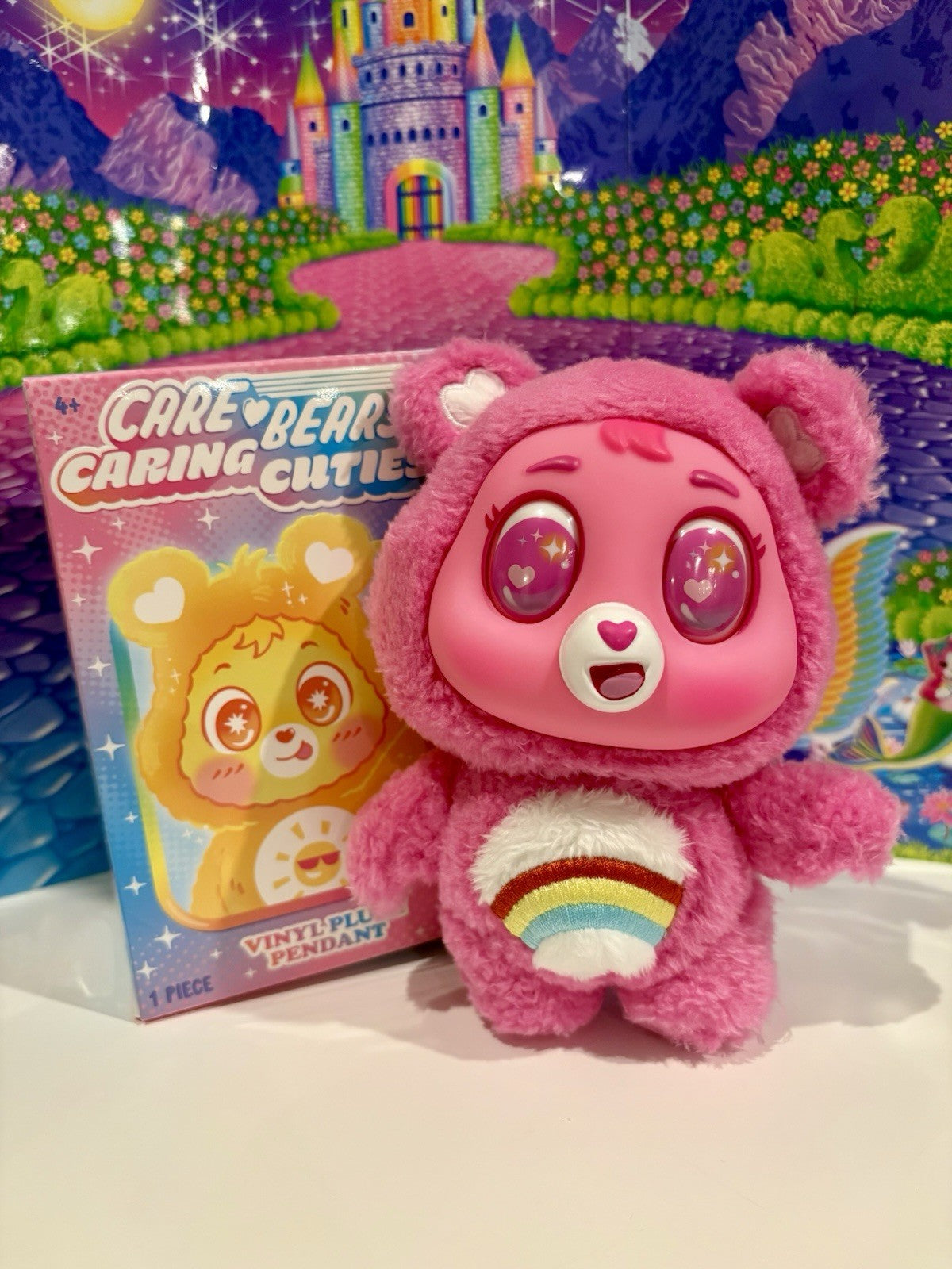 Pink Care Bears plush pendant with vinyl Cheer Bear face, with blind box package.