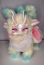 Fantasy creature plush front view with pastel blue ears, silver antlers, and pink eye makeup
