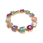 Gold-tone crystal bracelet with pastel multicolor round cushion stones and hinge clasp.