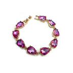 Teardrop crystal linked chain bracelet with purple-pink stones and gold-tone setting