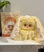 Yellow bunny blind box figurine with long plush ears and lace-trim dress