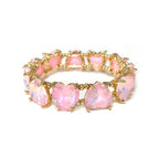 Pink crystal bead stretch bracelet with heart-shaped center stones and gold-tone linked design