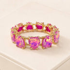 Plum crystal bead stretch bracelet with heart-shaped center stones and gold-tone links