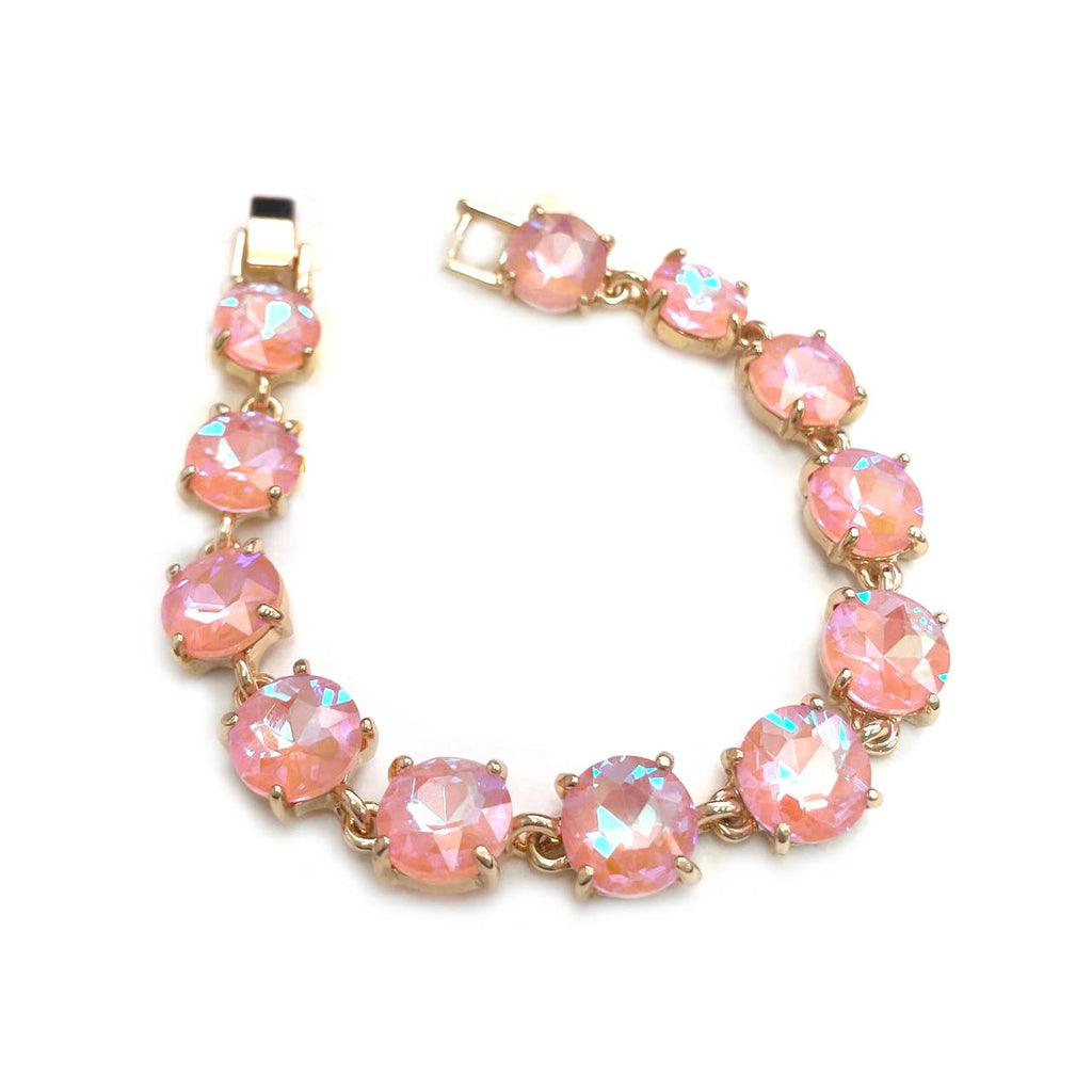 Gold-tone crystal bracelet with light pink round cushion stones and hinge clasp.