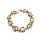 Teardrop crystal linked chain bracelet with peach stones and gold-tone setting