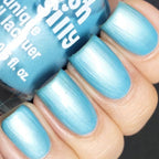 Sky blue creme nail polish on long nails, bottle partially visible