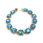 Gold-tone linked bracelet with bright blue cushion-cut crystals