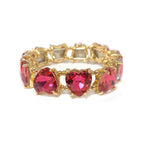 Pink/red crystal bead stretch bracelet with heart-shaped center stones and gold-tone links